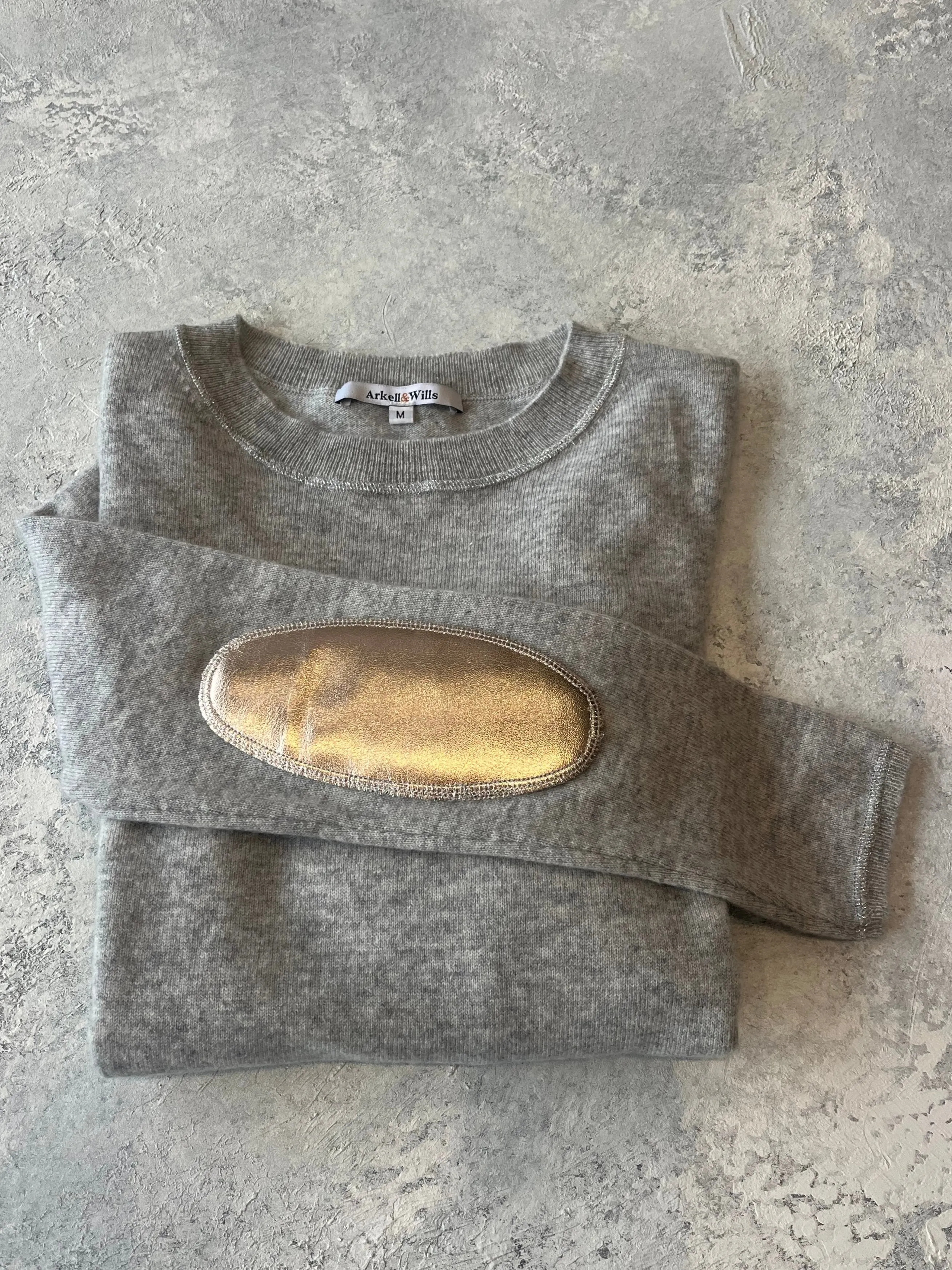 Grey boxy crew neck with rose gold faux leather elbow patches